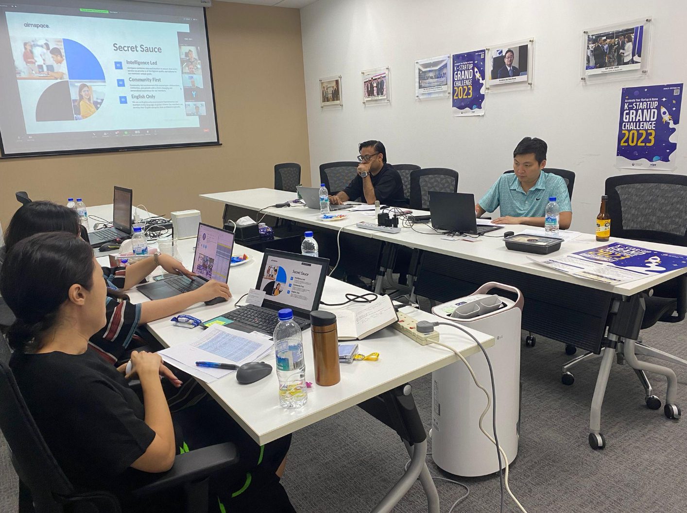 Judges and team reviewing startup pitches in a meeting room in Singapore during the K-Startup Grand Challenge
